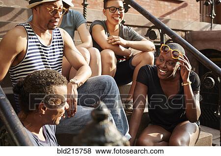 Friends relaxing on front stoop View Large Photo Image Stock Photo - Friends relaxing on front stoop. Fotosearch