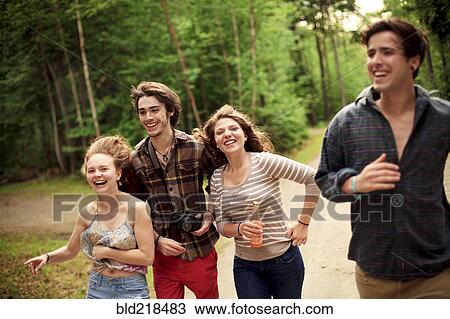 Friends running on dirt path in forest View Large Photo Image Stock Image - Friends running on dirt path in forest. Fotosearch