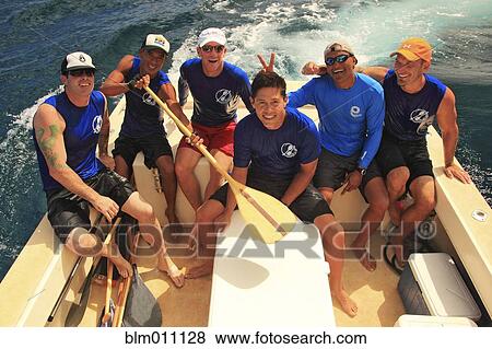 Friends sitting on back of boat on the ocean View Large Photo Image Stock Photo - Friends sitting on back of boat on the ocean. Fotosearch