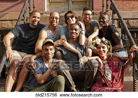 Stock Photograph - Friends smiling on front stoop. Fotosearch