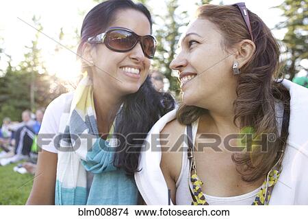 Picture - Friends smiling outdoors. Fotosearch