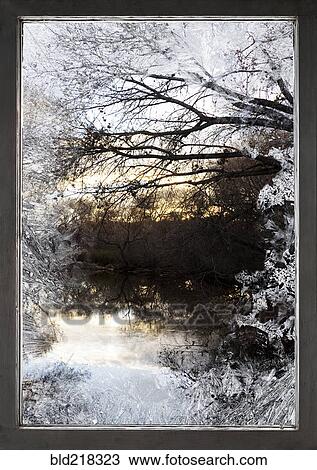 Stock Image - Frosty window and view of rural lake. Fotosearch