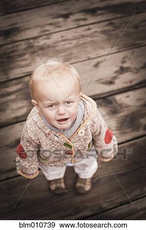 Frowning Caucasian boy standing outdoors View Large Photo Image Stock Photo - Frowning Caucasian boy standing outdoors. Fotosearch