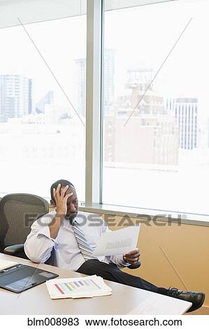 Frustrated Black businessman working in conference room View Large Photo Image Stock Image - Frustrated Black businessman working in conference room. Fotosearch