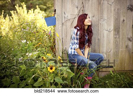 Gardener sitting near wooden shed in backyard View Large Photo Image Picture - Gardener sitting near wooden shed in backyard. Fotosearch
