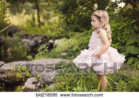 Girl in frilly dress exploring creek View Large Photo Image Stock Photography - Girl in frilly dress exploring creek. Fotosearch