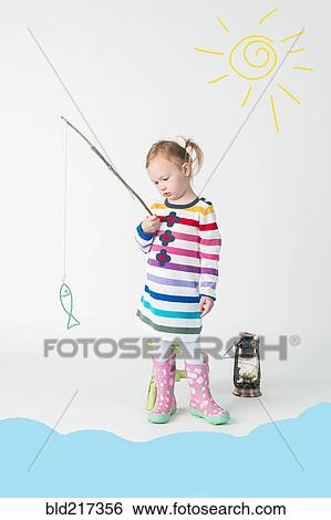 Stock Photograph - Girl playing fishing with toy fish. Fotosearch