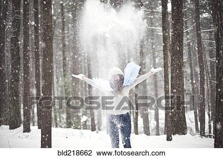 Stock Image - Girl playing in snowy forest. Fotosearch