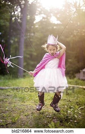 Picture - Girl playing princess in backyard. Fotosearch