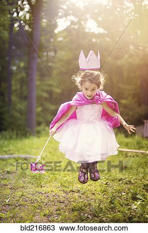 Stock Image - Girl playing princess in backyard. Fotosearch