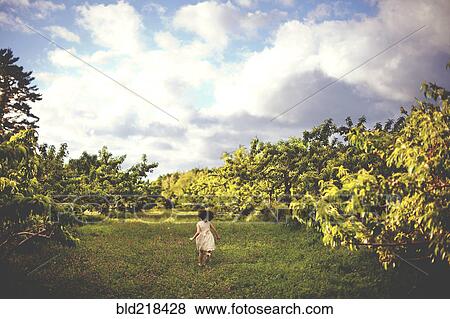 Stock Photo - Girl running in rural field. Fotosearch