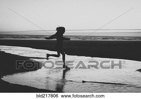 Stock Photograph - Girl running on beach. Fotosearch