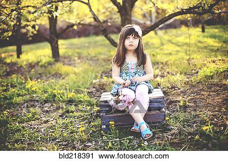 Girl sitting on crate in orchard View Large Photo Image Stock Image - Girl sitting on crate in orchard. Fotosearch