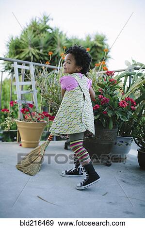 Girl sweeping patio with broom View Large Photo Image Stock Photo - Girl sweeping patio with broom. Fotosearch