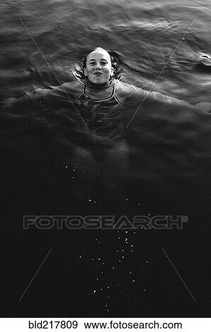 Stock Photo - Girl swimming in lake. Fotosearch