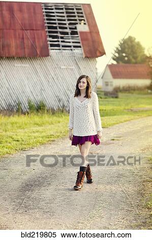 Girl walking on dirt path in rural farm View Large Photo Image Stock Photography - Girl walking on dirt path in rural farm. Fotosearch