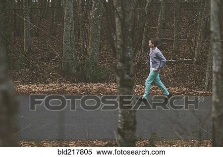 Stock Photography - Girl walking on rural road. Fotosearch