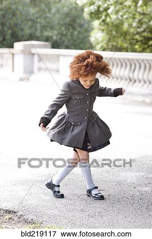 Girl walking on sidewalk View Large Photo Image Stock Photo - Girl walking on sidewalk. Fotosearch