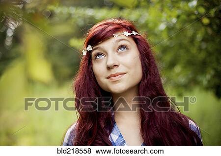Stock Photo - Girl wearing flower crown in rural field. Fotosearch