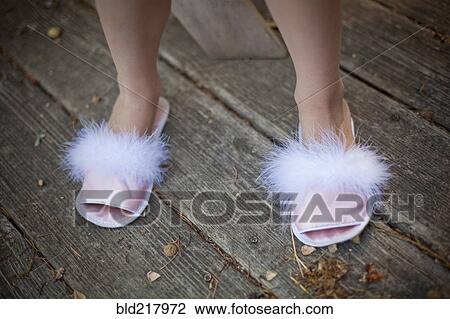 Girl wearing fuzzy slippers on deck View Large Photo Image Stock Image - Girl wearing fuzzy slippers on deck. Fotosearch