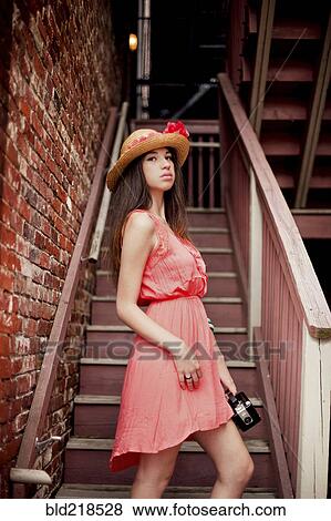 Girl wearing straw hat on staircase View Large Photo Image Stock Photo - Girl wearing straw hat on staircase. Fotosearch