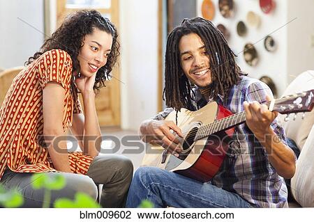 Girlfriend watching boyfriend playing guitar View Large Photo Image Stock Image - Girlfriend watching boyfriend playing guitar. Fotosearch