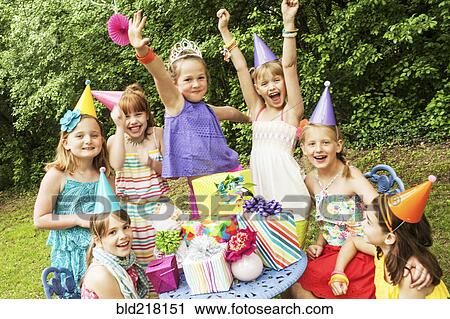 Girls cheering with gifts at birthday party View Large Photo Image Stock Image - Girls cheering with gifts at birthday party. Fotosearch