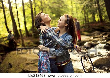 Girls hugging in forest creek View Large Photo Image Stock Image - Girls hugging in forest creek. Fotosearch