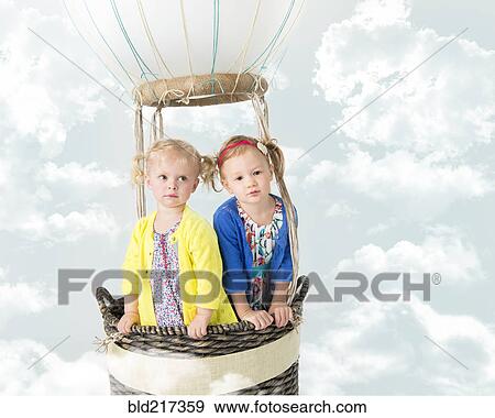 Stock Photo - Girls playing in pretend hot air balloon. Fotosearch