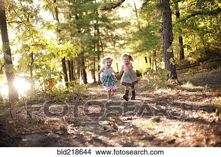 Picture - Girls running on forest path. Fotosearch