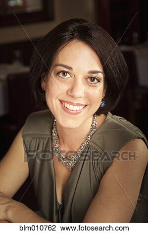 Stock Image - Glamorous Caucasian woman in restaurant. Fotosearch