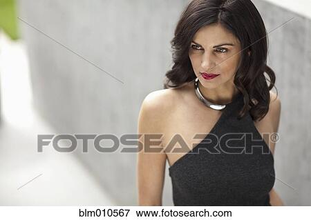 Glamorous Caucasian woman standing outdoors View Large Photo Image Stock Photo - Glamorous Caucasian woman standing outdoors. Fotosearch