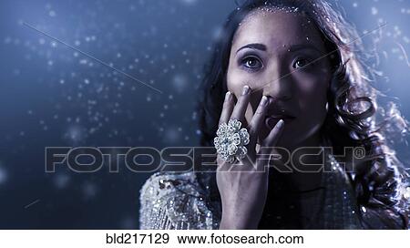 Stock Photo - Glamorous Chinese woman covering her face. Fotosearch