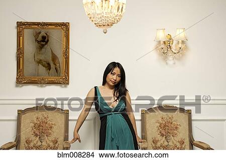 Glamorous Vietnamese woman standing in elegant room View Large Photo Image Picture - Glamorous Vietnamese woman standing in elegant room. Fotosearch