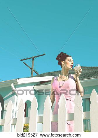 Stock Photo - Glamorous woman in vintage clothing drinking cocktail. Fotosearch