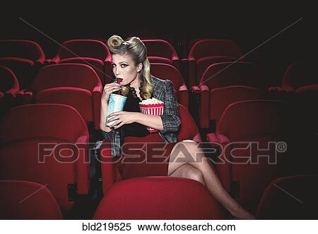Glamorous woman in vintage clothing watching movie in theater View Large Photo Image Stock Photography - Glamorous woman in vintage clothing watching movie in theater. Fotosearch
