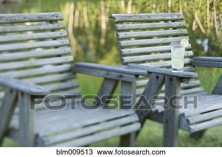 Glass of lemonade on wooden chair View Large Photo Image Stock Image - Glass of lemonade on wooden chair. Fotosearch