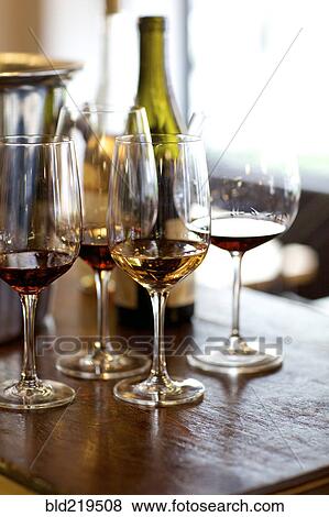 Glasses of red and white wine on table View Large Photo Image Stock Photo - Glasses of red and white wine on table. Fotosearch