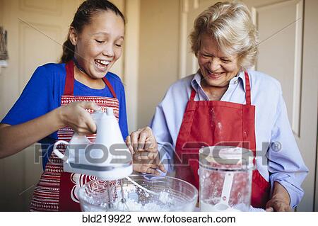 Grandmother and granddaughter baking in kitchen View Large Photo Image Stock Image - Grandmother and granddaughter baking in kitchen. Fotosearch