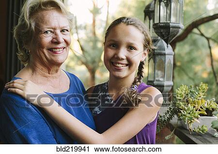 Grandmother and granddaughter smiling on porch View Large Photo Image Stock Image - Grandmother and granddaughter smiling on porch. Fotosearch