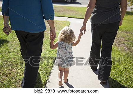 Grandmother, mother and daughter walking on sidewalk View Large Photo Image Stock Photo - Grandmother, mother and daughter walking on sidewalk. Fotosearch