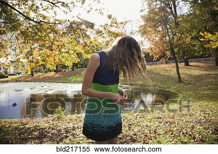 Hair hiding face of woman near duck pond in park View Large Photo Image Stock Photography - Hair hiding face of woman near duck pond in park. Fotosearch