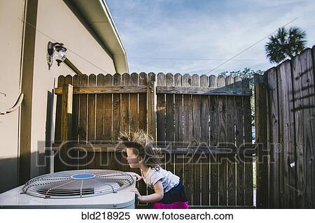 Hair of mixed race girl blowing from outdoor fan View Large Photo Image Stock Photography - Hair of mixed race girl blowing from outdoor fan. Fotosearch