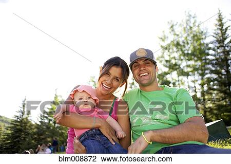 Happy family laughing outdoors View Large Photo Image Stock Image - Happy family laughing outdoors. Fotosearch