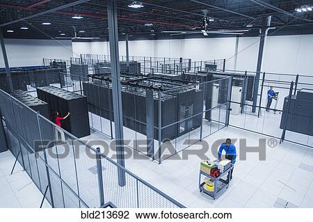 Stock Image - High angle view of Black businessman working in server room. Fotosearch