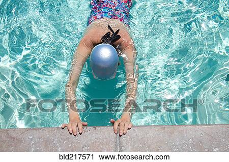 Stock Image - High angle view of Caucasian woman swimming in pool. Fotosearch