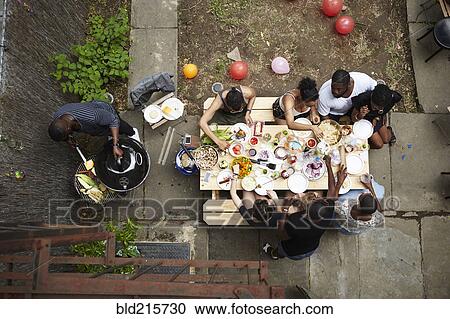 High angle view of friends enjoying backyard barbecue View Large Photo Image Stock Image - High angle view of friends enjoying backyard barbecue. Fotosearch