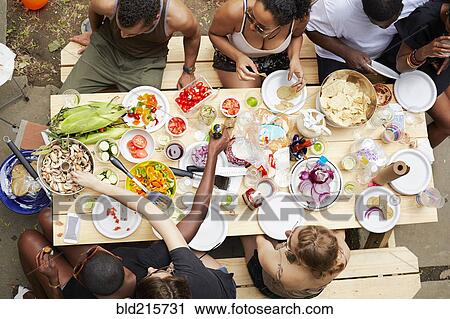 High angle view of friends enjoying backyard barbecue View Large Photo Image Stock Image - High angle view of friends enjoying backyard barbecue. Fotosearch