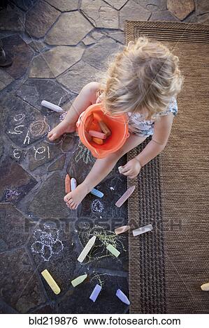 High angle view of girl drawing with chalk on tile View Large Photo Image Stock Photograph - High angle view of girl drawing with chalk on tile. Fotosearch
