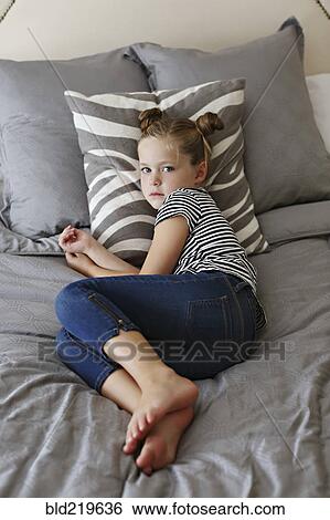 High angle view of girl laying on bed View Large Photo Image Stock Photograph - High angle view of girl laying on bed. Fotosearch